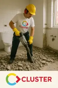 Cluster Services demolition specialist breaking bathroom tiles with jackhammer in Adelaide